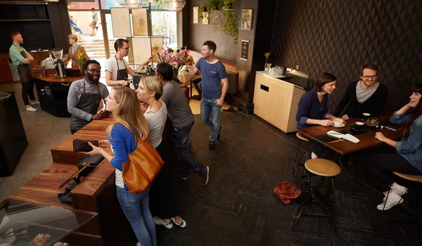 Modern coffee shop with smiling customers