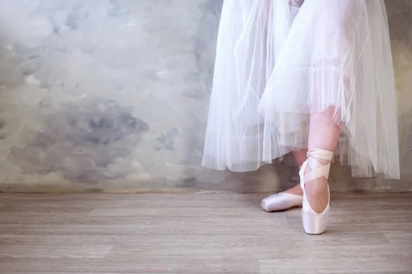 Legs of a ballerina in pointe shoes