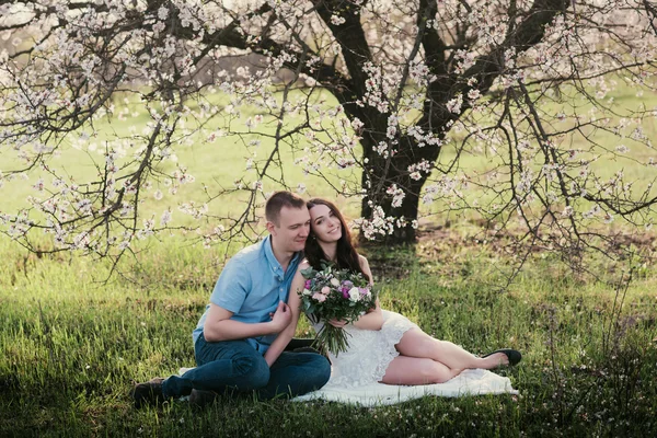 Young couple sitting in spring nature close-up portrait