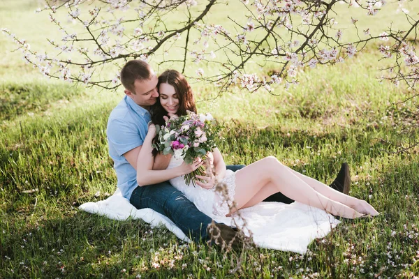 Young couple sitting in spring nature close-up portrait