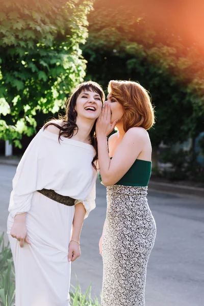 Two beautiful women talking, laughing