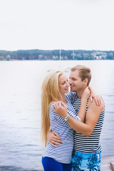 Portrait of a romantic couple in a striped T-shirt hugging and smiling