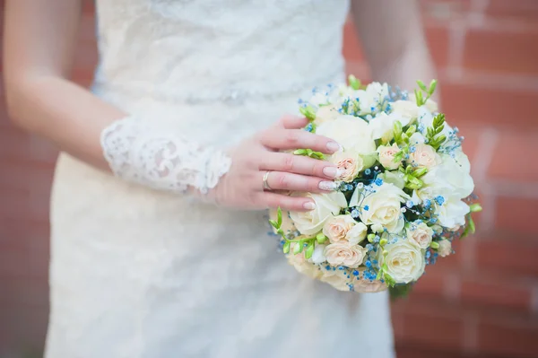 Beautiful wedding bouquet in hands of the bride