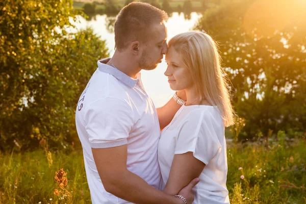 Young couple in the woods at sunset