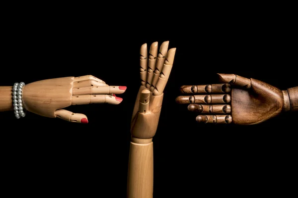A woman\'s hand and one hand of black man meet