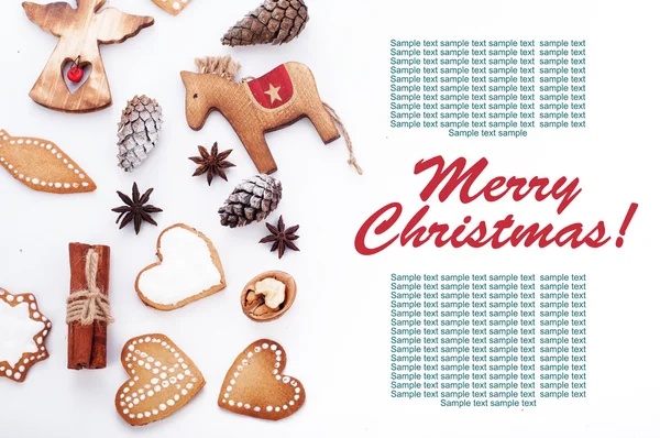 New Year\'s and Christmas background. Christmas ornaments, pine cones, cinnamon and ginger biscuits with meringue on a white background. Place for writing the text or congratulations