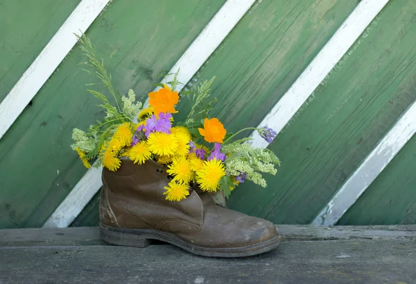 Bouquet in old boots