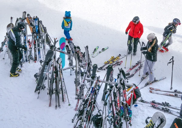 Skis and ski poles are standing front of a restaurant. Skiers went to dinner. Ski resort