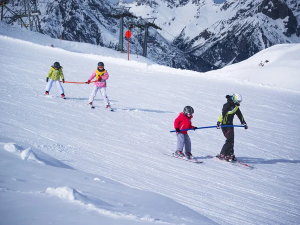 Little skiers do exercise on the hill. Children ski school in Austria, Zams on 22 Feb 2015. Skiing, winter season, Alps