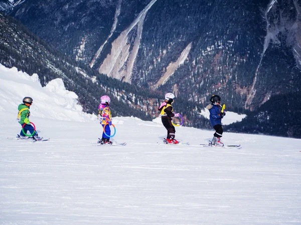 Little skiers do exercise on the hill. Children ski school in Austria, Zams on 22 Feb 2015