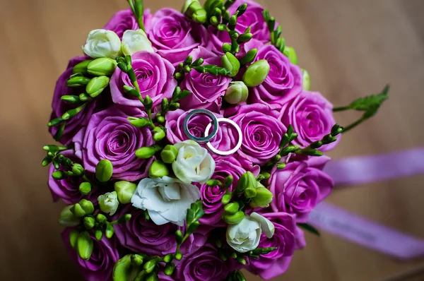Wedding flowers,infinity sign of the rings, wedding rings on a white background