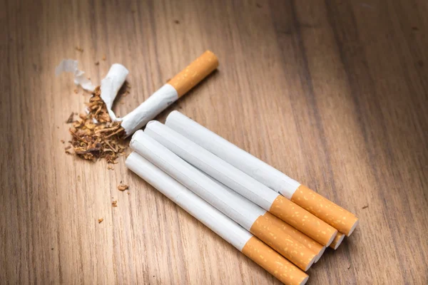 Stop smoking Tobacco ,tear cigarette detrimental on wood background