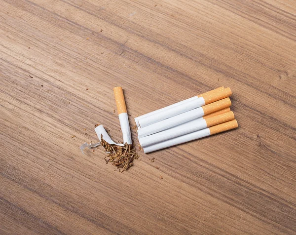 Stop smoking Tobacco ,tear cigarette detrimental on wood background