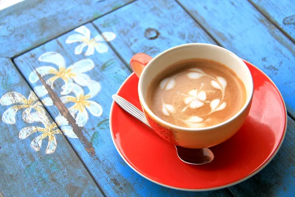 Red cup of coffee with heart and flower painted on foam