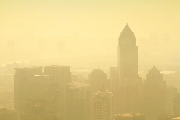 Low visibility caused by pollution problem in urban area during golden sunset, Bangkok, THAILAND.