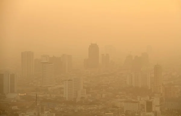 Low visibility caused by pollution problem in urban area during golden sunset, Bangkok, THAILAND.