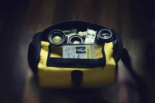 Yellow bag with camera parts