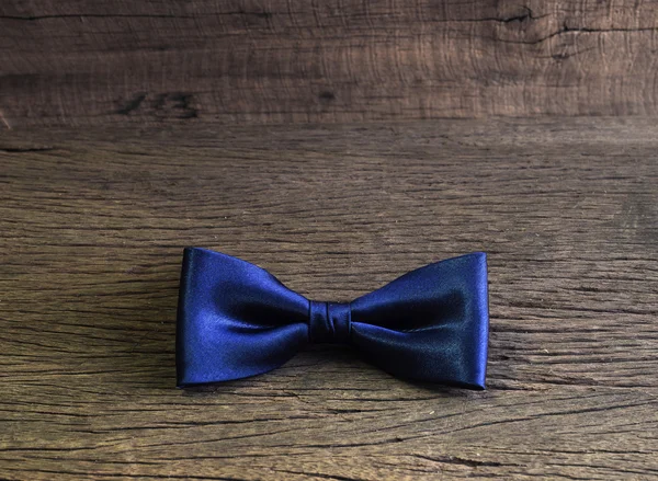 Dark blue bow tie on the wooden table