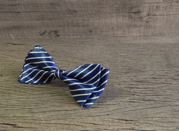 Dark blue bow tie on the wooden table