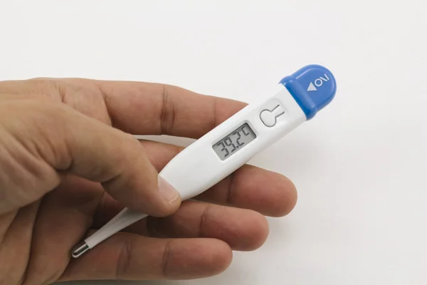 Human hand holding a thermometer, with high fever