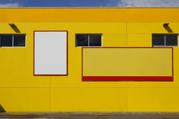 Blank billboard in a yellow wall, for advertisement