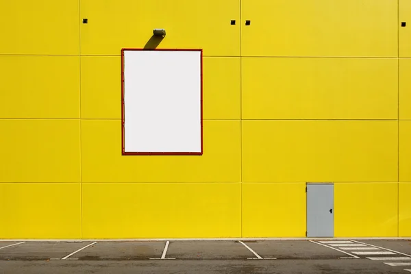Blank billboard in a yellow wall