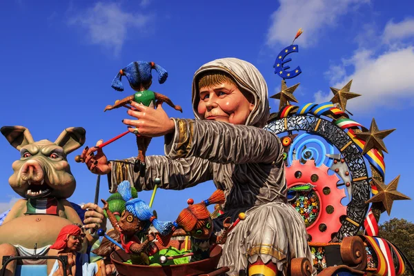 Putignano,Apulia,Italy - February 15, 2015: carnival floats, giant paper mache. European politician: Angela Merkel. Carnival Putignano: floats. Angela Merkel torture the European Community.