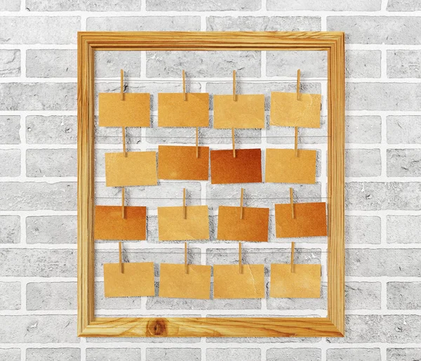 Picture frame and antique note papers on white brick wall