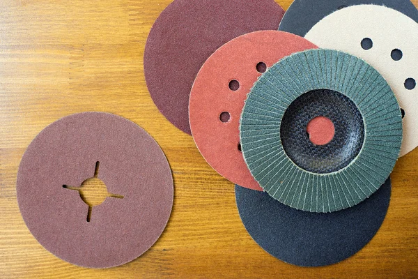 Abrasive materials - sheets of sandpaper and disks close-up