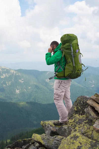 Man hiker on a top of a mountain