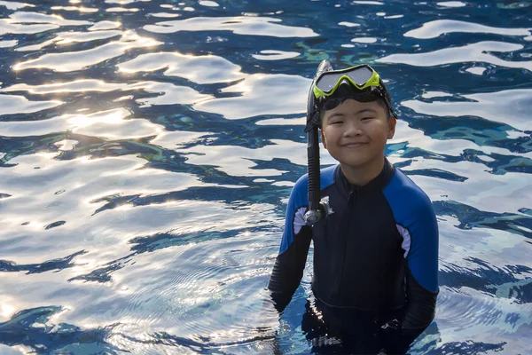 Happy kids snorkelling mask in water summer vacation