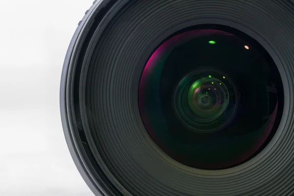 Front view of black camera lens isolated on white background