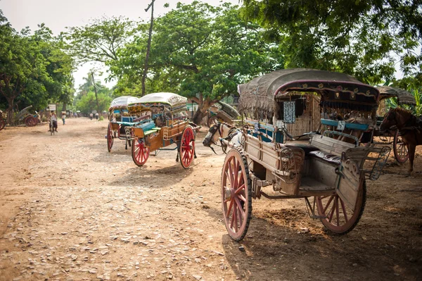 INWA,MYANMAR-MAY 2,2013 : Unidentified carriage of passengers and carrying supplies the local road runs along to a village onMAY 2,2013 in Inwa ancient city,Mandalay State in Middle of Myanmar.
