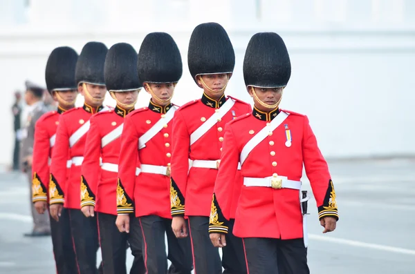 Soldiers in parade uniforms marching during the royal funeral of Her Royal Highness Princess Bejaratana