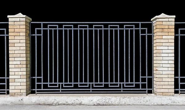 Metal fence with brick pillars