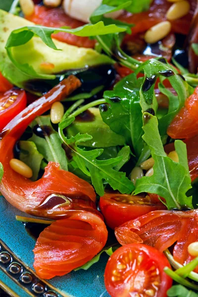 Salmon, cherry tomatoes, arugula salad, pine nuts and mozzarella