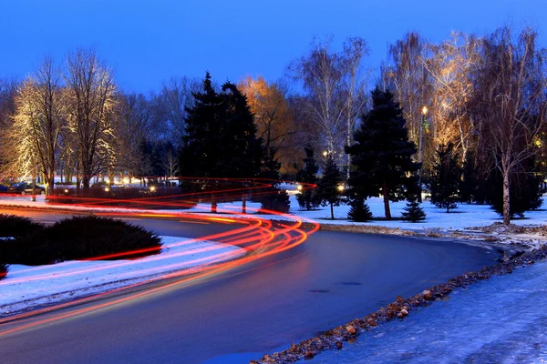 The lights of cars on the road  in winter.