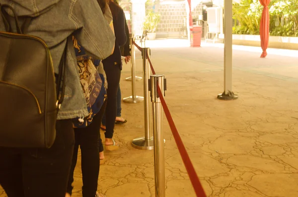 Tourist in a long  queue