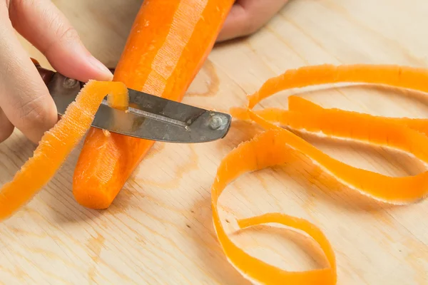 Peeling fresh carrot