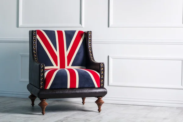 Chair with British flag on background of white wall