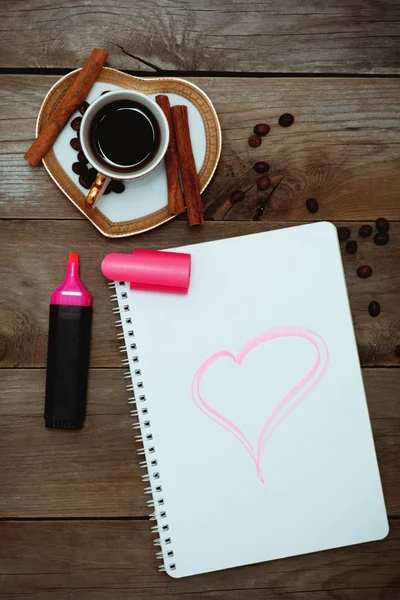 Notepad with a painted heart, coffee and flowers