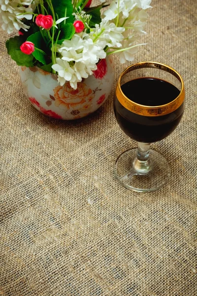 Two glasses of red wine and flowers