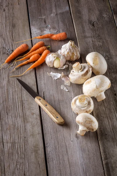 Ingredients for cooking: mushrooms, carrots and garlic