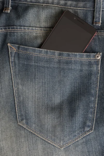 Modern red phone  in jeans pocket displaying