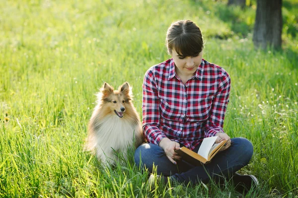 Student girl learning in nature with dog