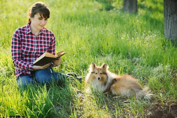 Student girl learning in nature with dog