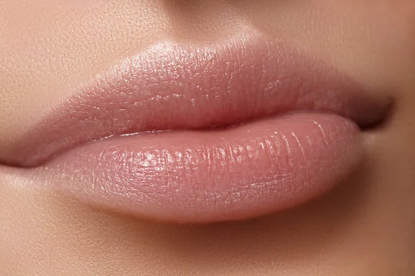 Face part. Beautiful female lips with natural makeup, clean skin. Macro shot of female lip, clean skin. Fresh kiss. Spa beauty cosmetics
