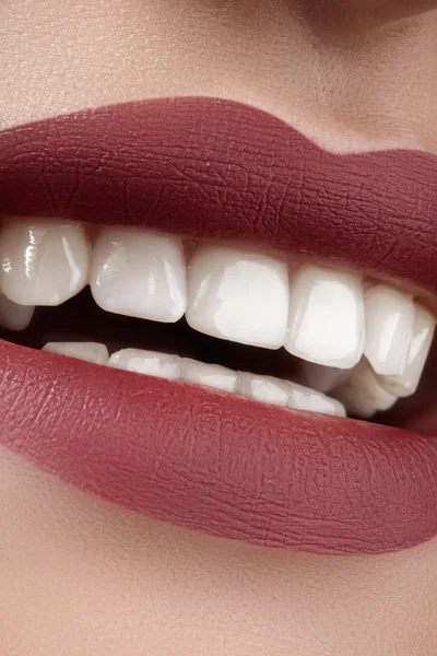 Beautiful smile with whitening teeth. Dental photo. Perfect fashion lips makeup. Health happy female smile. Macro close-up shot of woman\'s mouth. Care about tooth