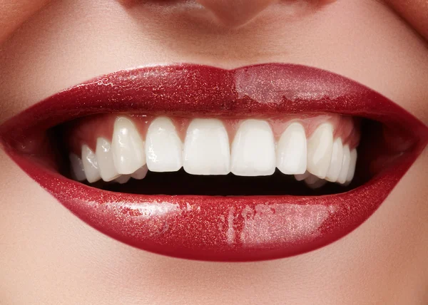 Beautiful smile with whitening teeth. Dental photo. Perfect fashion lips makeup. Health happy female smile. Macro close-up shot of woman's mouth. Care about tooth