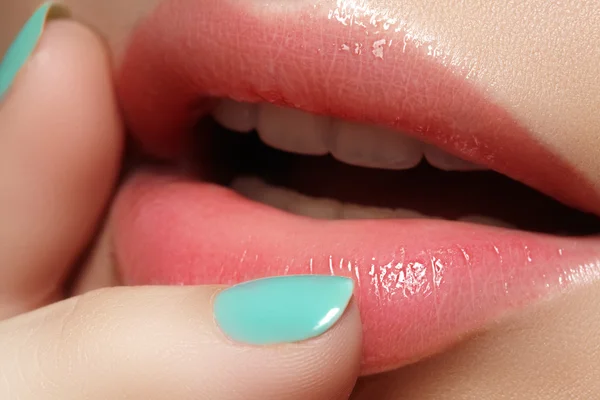 Close-up of woman\'s lips with fashion make-up and manicure. Beautiful female full lips with perfect makeup. Natural visage. Part of female face. Macro shot of beautiful make up on full lips.